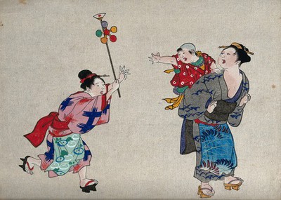 image of 'Japanese woman gives a toy to a child on another lady's back'