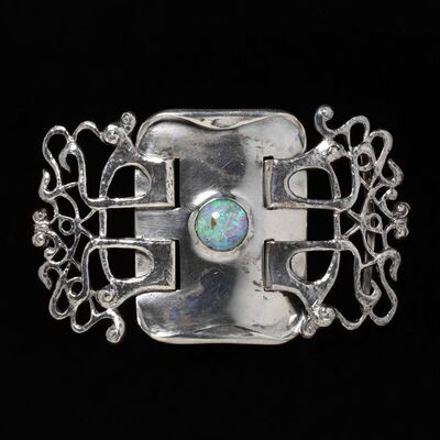 Waist clasp of silver and opal in two parts, probably designed by Oliver Baker and made b Haseler & Co., Birmingham, 1899-1900. Waist clasp of silver, set with an opal; in two parts.  Silver, opal.