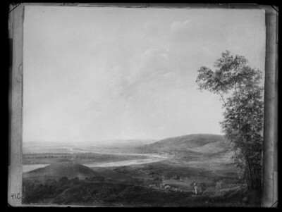 A hilly river landscape with a city