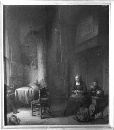 Kitchen with potato peeling woman, next to her a boy