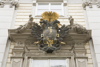 Two women holding a crown, imperial coat of arms with imperial eagle