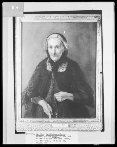 Portrait of an old lady with rosary and fan