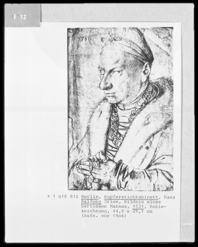 Chest image of a distinguished, elderly man, praying with rosary