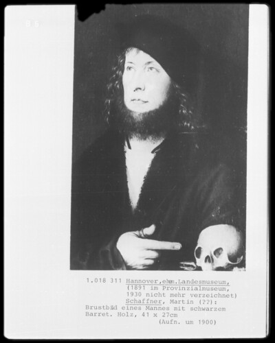 Chest image of a man with black beret and skull