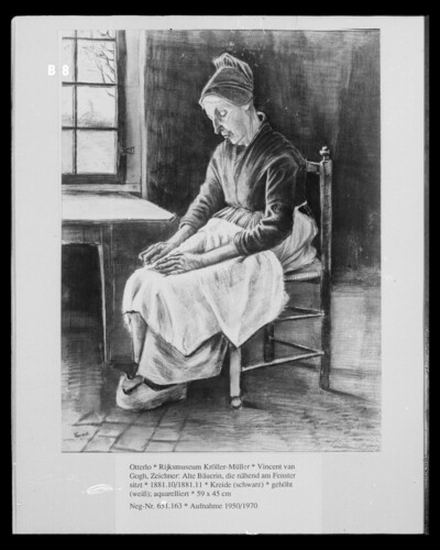 Old peasant woman sitting near the window