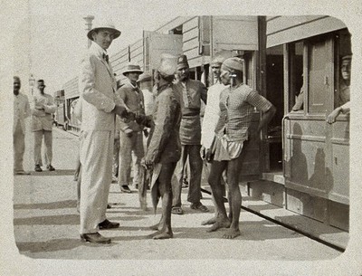 Medical officers watching the arrival of a train at Sion railway station, during the epidemic of plague in Bombay. Photograph attributed to Captain C. Moss, 1897.