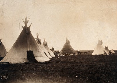 A Piegan Indian encampment, North America: tipis, including a decorated medicine tipi (centre).