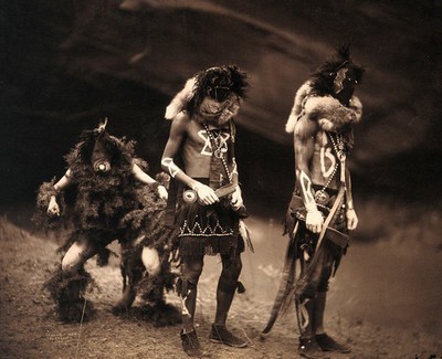 Three Navajo men proceeding as war gods.