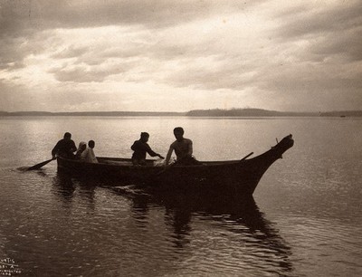 Salish Indians in a canoe on Puget Sound, North America.