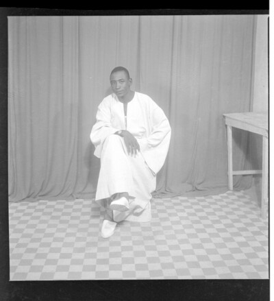Full frontal view of a man sitting in the studio wearing a boubou.From Endangered Archives Programme EAP449, "Social history and cultural heritage of Mali"
