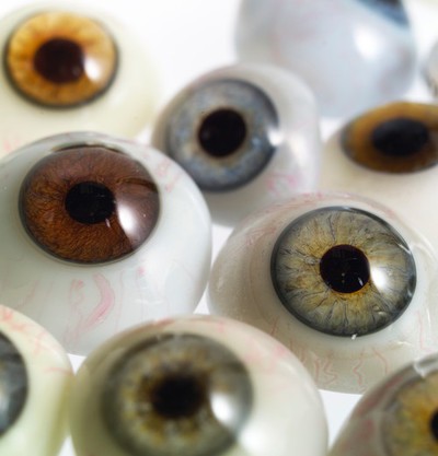 A selection of glass eyes from an opticians glas eye case