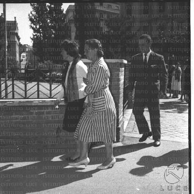 Two women walk away from the entrance gate of the church of S ...