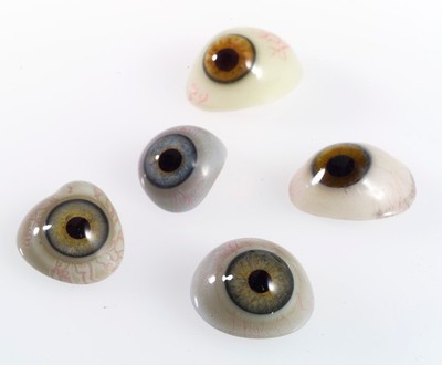 A selection of glass eyes from an opticians glass eye case.