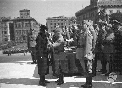 Vittorio Emanuele delivers the medal to the military valor to a war ...