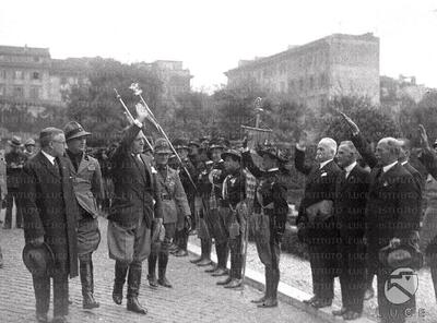 Mussolini accompanied by Michele Bianchi and Alessandro Melchiori